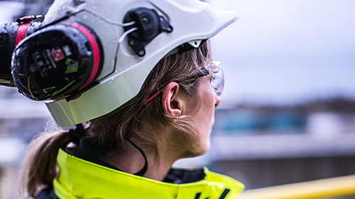 Female oil refinery worker gazing